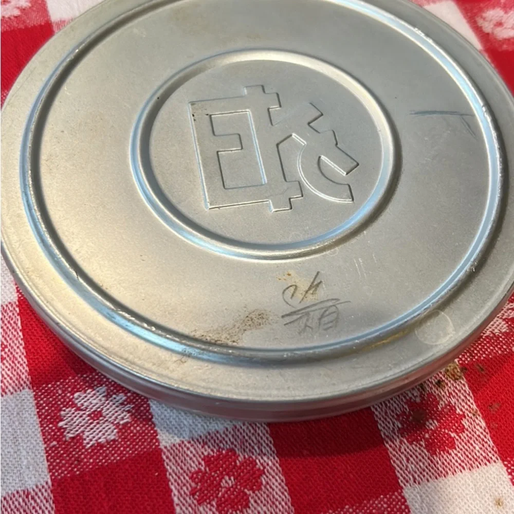 Vintage tin movie reel container with lock